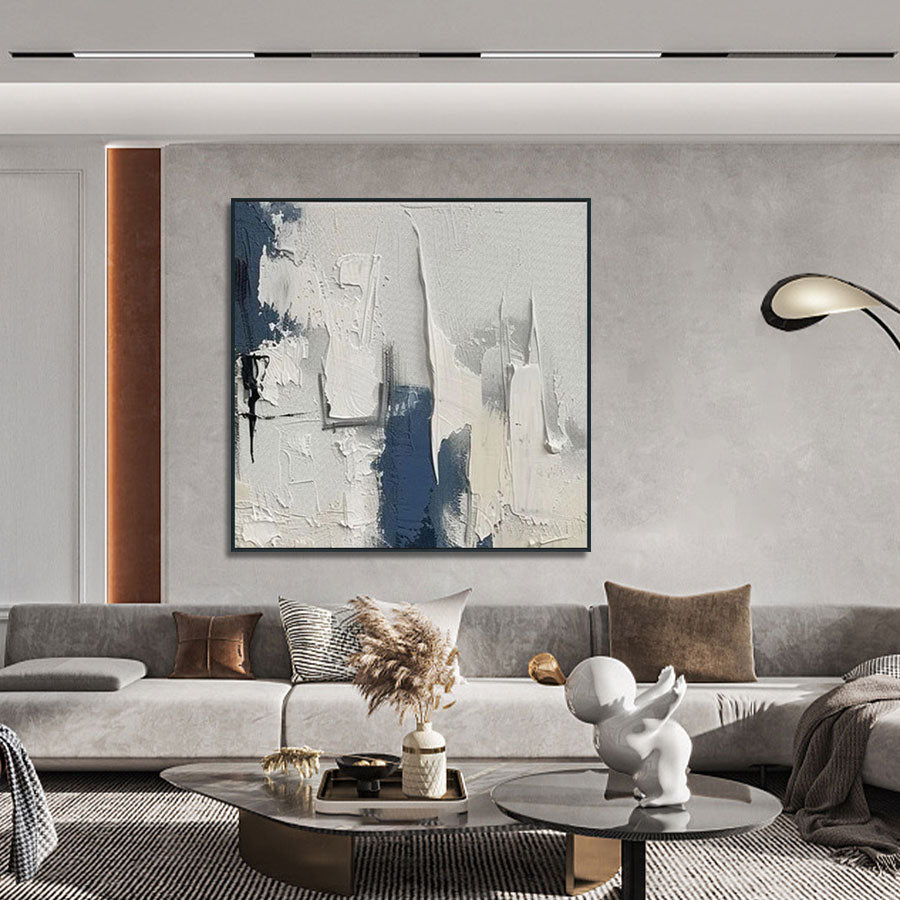 Modern living room with abstract art, gray sofa, and decorative items.