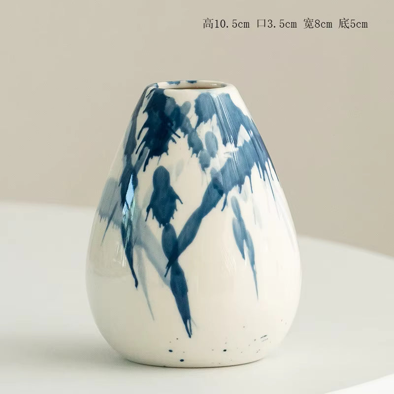 White vase with blue abstract patterns on a light background