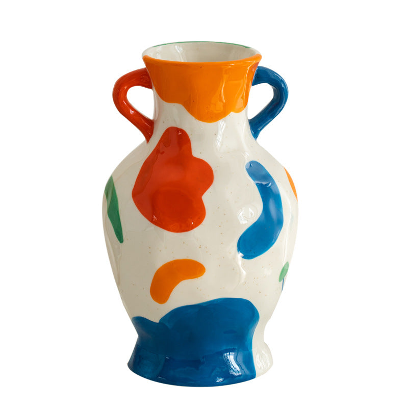 Colorful ceramic vase with abstract design on a white background