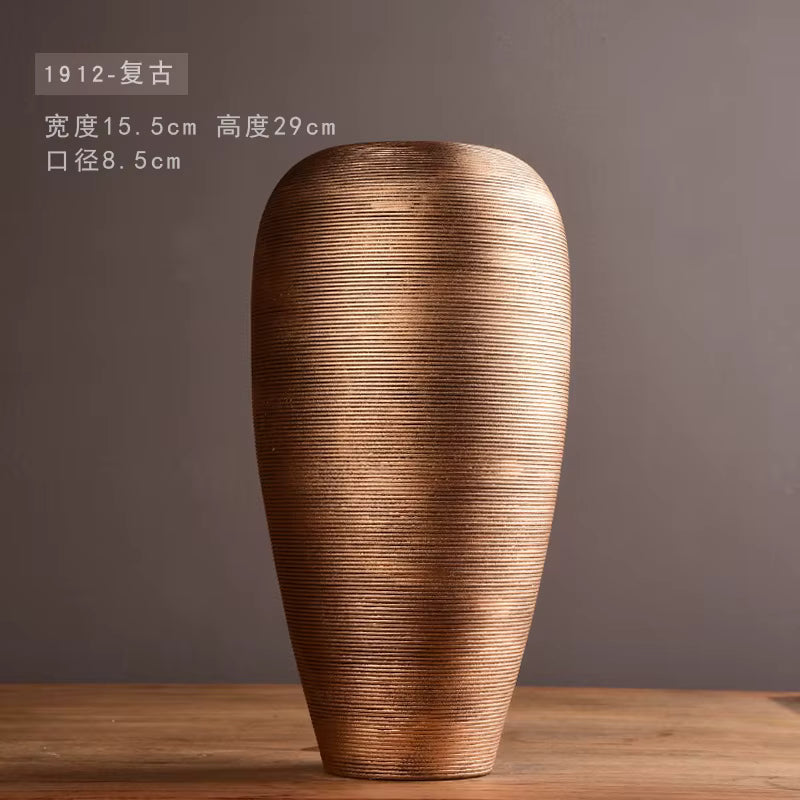Decorative vase with textured surface on a wooden table against a dark background