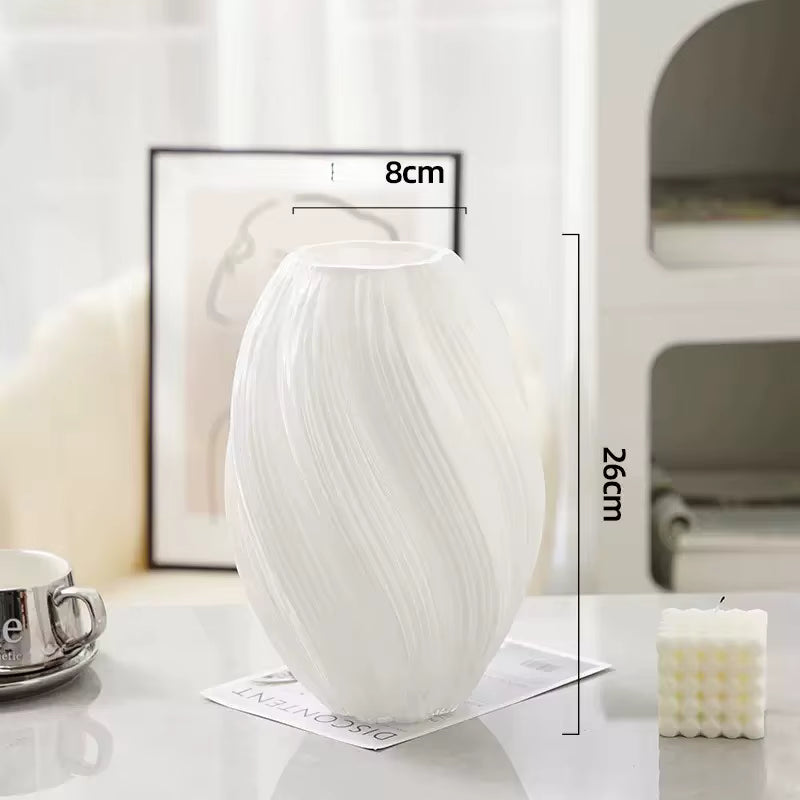 White vase with dimensions on a table with a blurred background