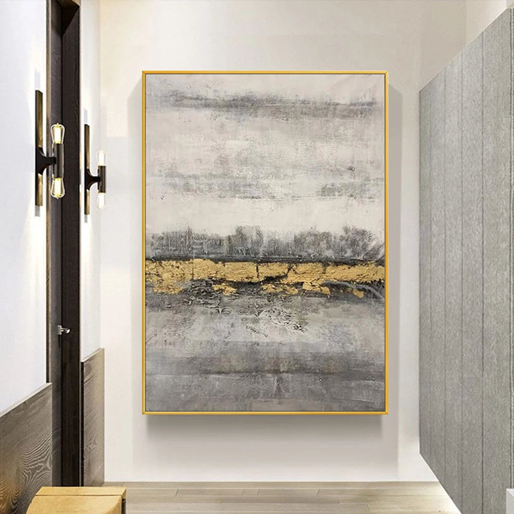 Abstract art piece with gold accents on a wall in a modern interior setting.