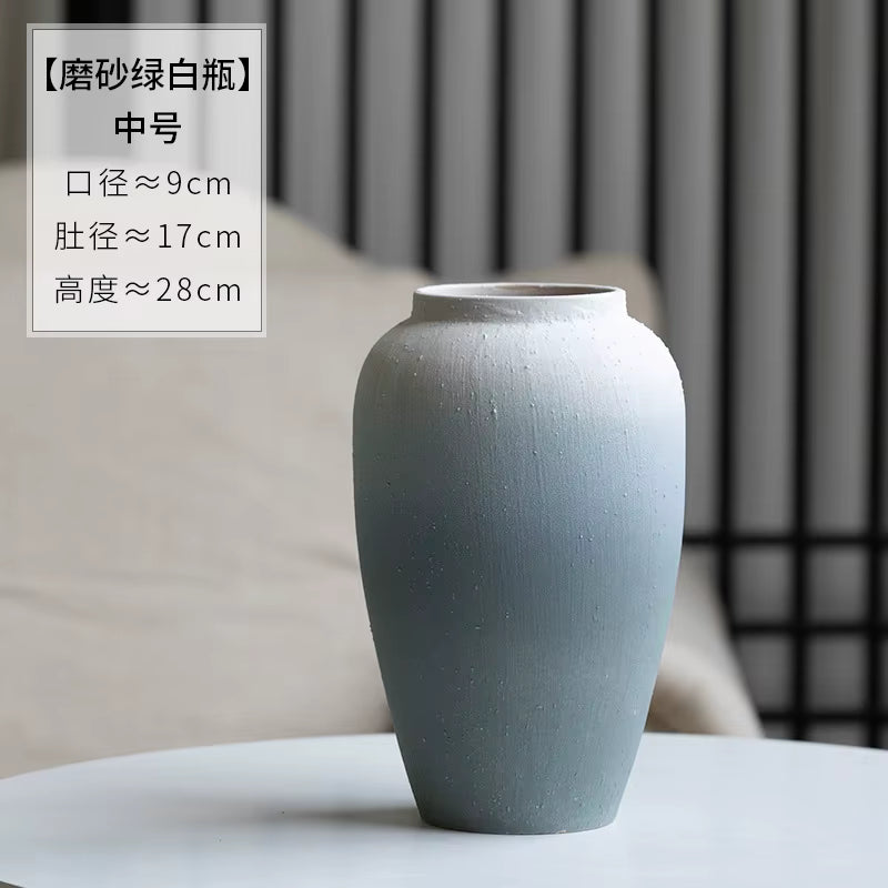 Gray ceramic vase on a table with text overlay