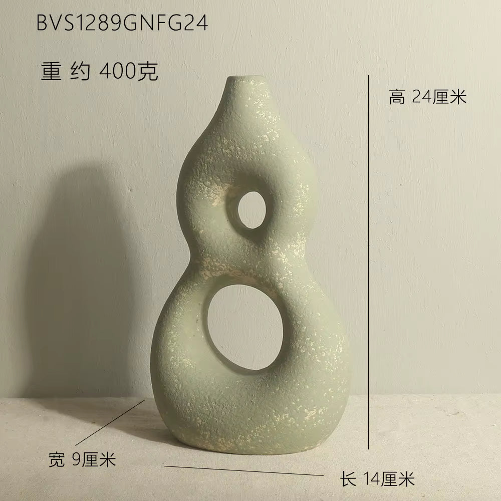 Decorative vase with circular holes on a plain background