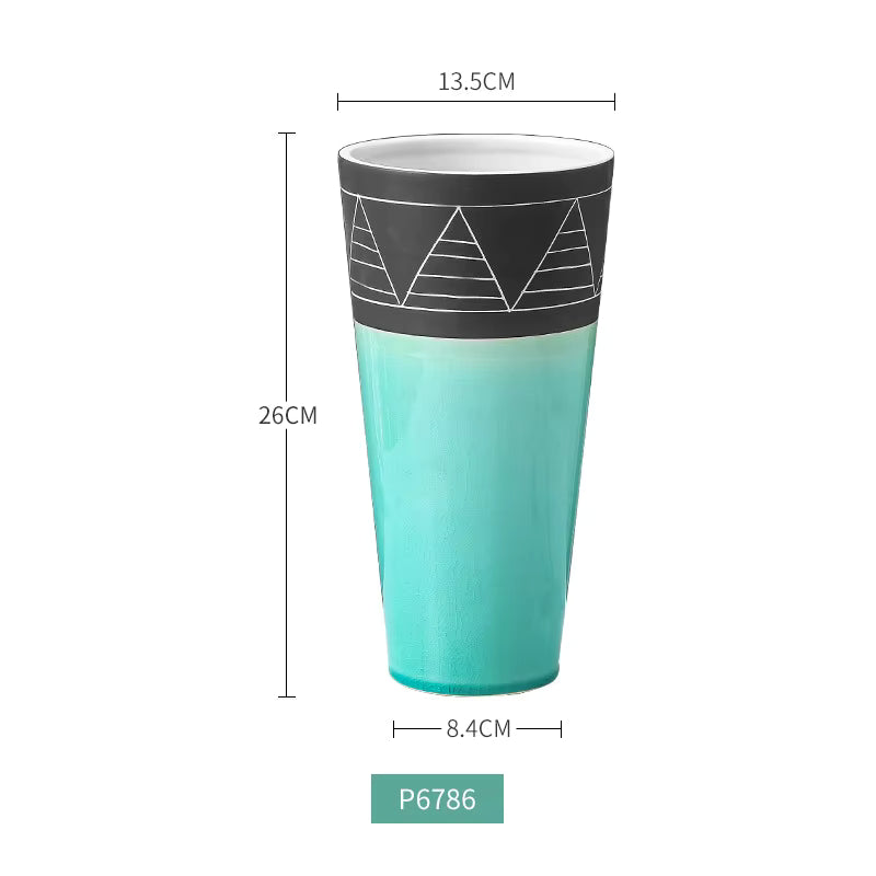 Turquoise tumbler with black band and geometric design, shown with measurements on a white background.