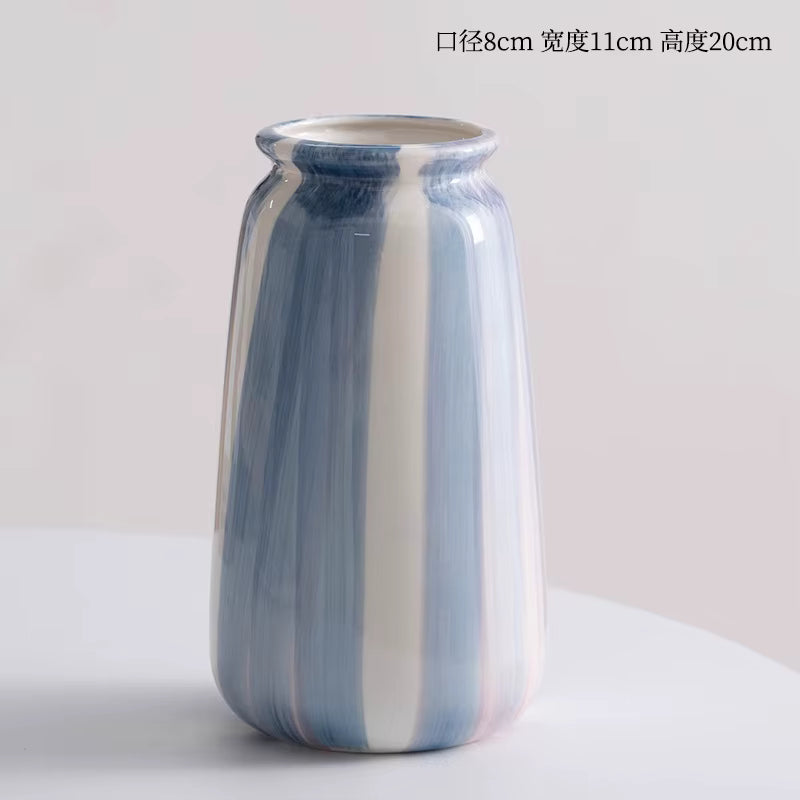 Striped ceramic vase on a light gray background