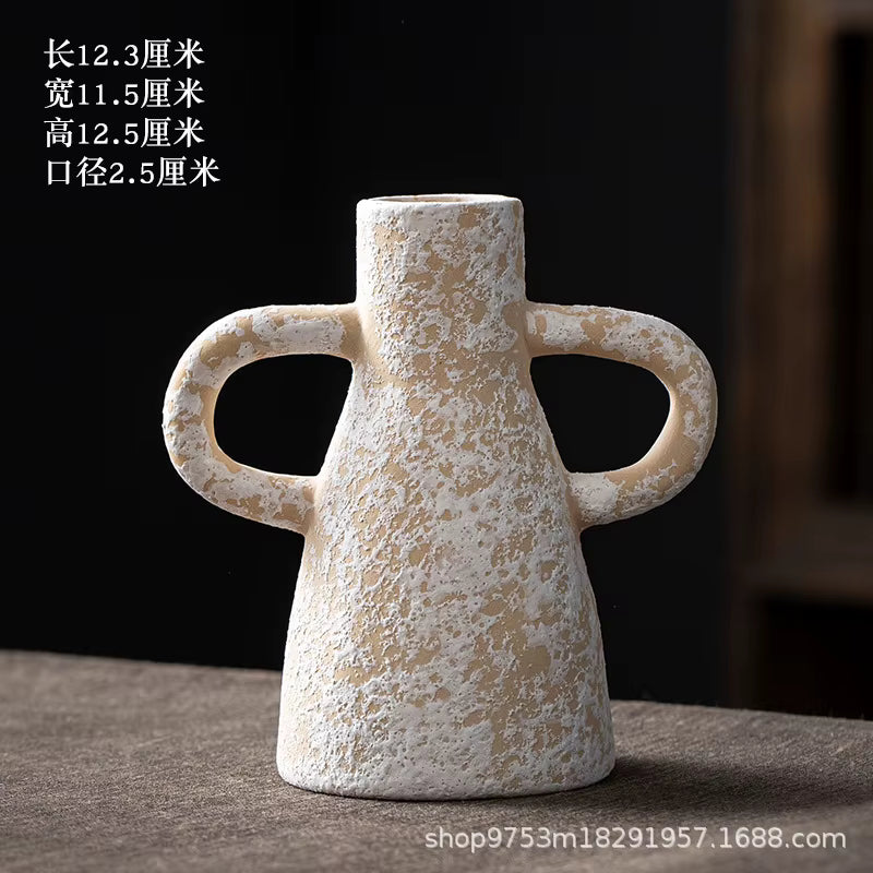 Decorative ceramic vase with handles on a dark background