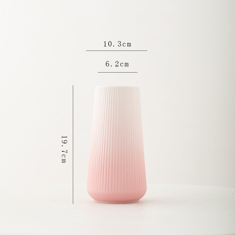 Pink ceramic vase with measurements on a white background