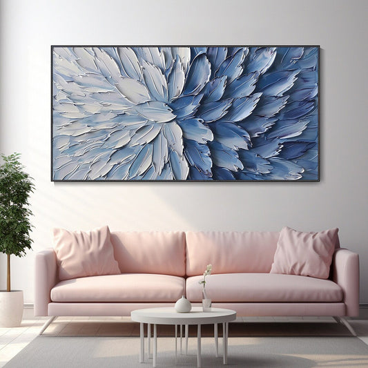 Living room with a pink sofa, coffee table, and abstract blue artwork on the wall.