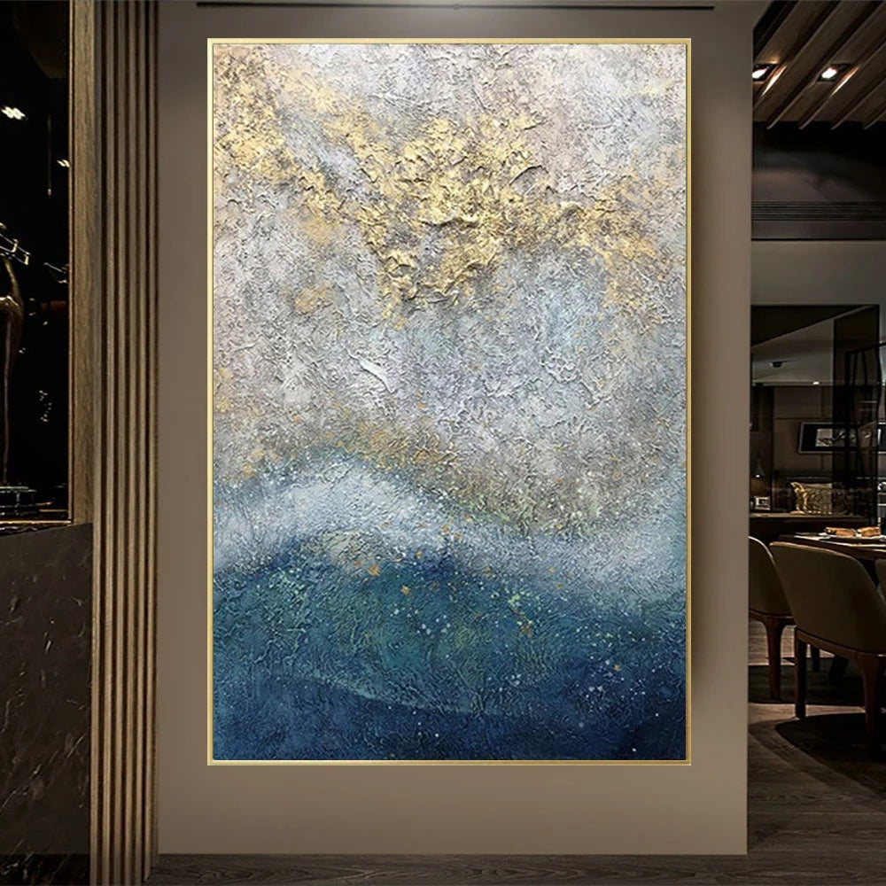 Abstract art piece with gold and blue tones in a modern interior setting