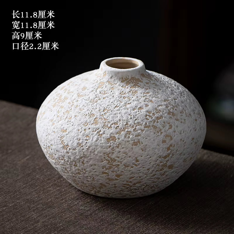Textured ceramic vase on a dark surface with dimensions displayed