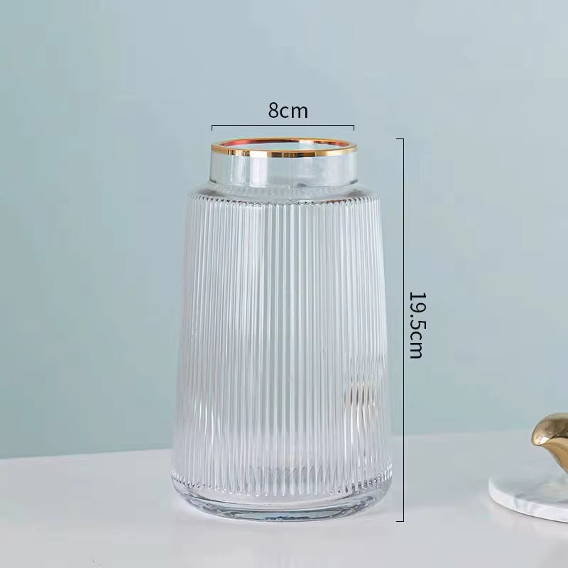 Clear glass jar with gold rim and measurements on a light gray background