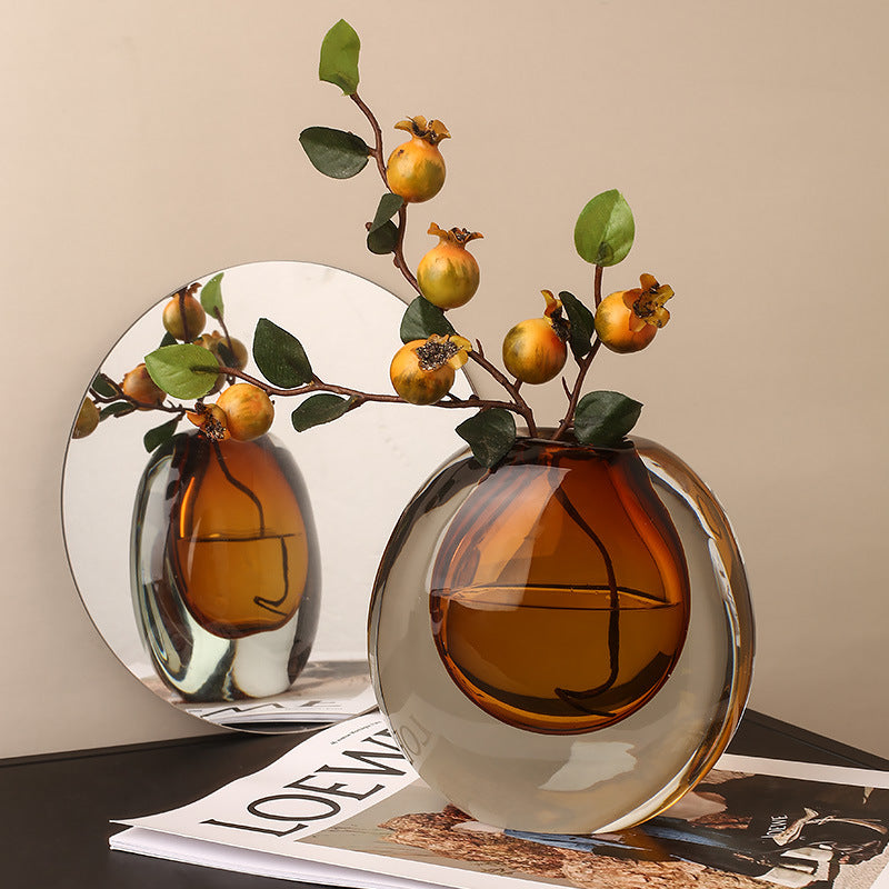 Decorative vase with branches and fruits on a table