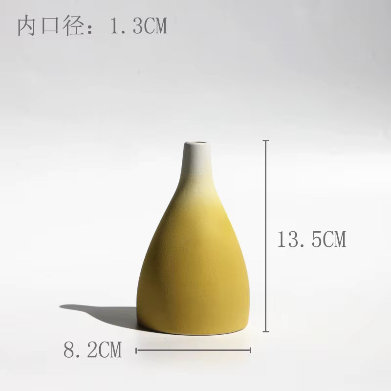 Yellow and white ceramic vase with dimensions on a light gray background