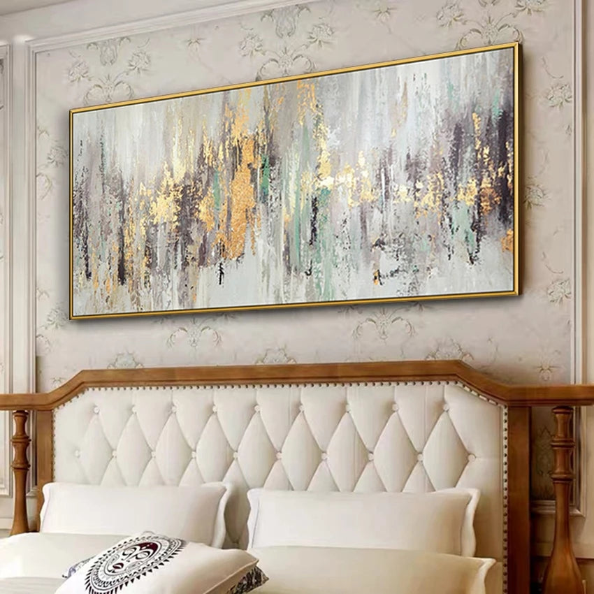 Abstract painting with gold accents on a wall above a wooden headboard in a bedroom.