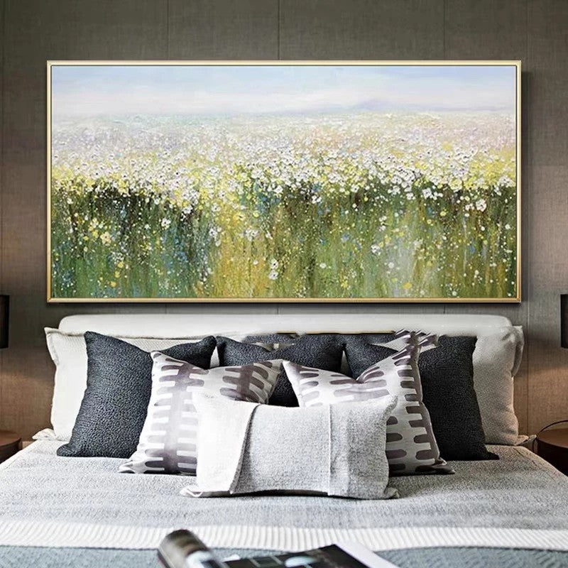 Bedroom with a large abstract painting of a field above a bed with patterned pillows.