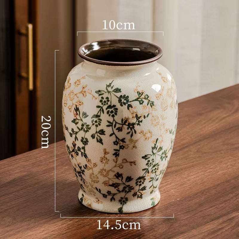 Ceramic vase with floral patterns on a wooden surface, showing measurements.