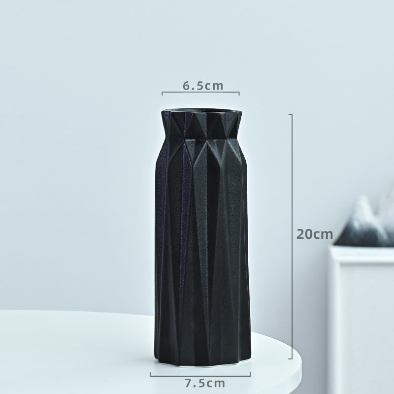 Black geometric vase with measurements on a light gray background