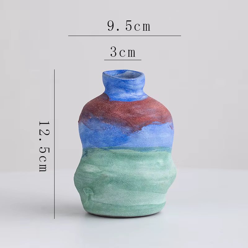 Multicolored ceramic vase with measurements on a light gray background