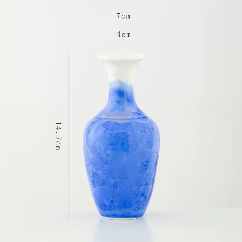 Blue ceramic vase with measurements on a white background
