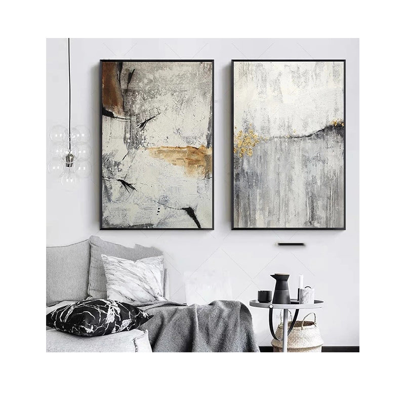 Two abstract art pieces on a wall above a sofa in a living room.