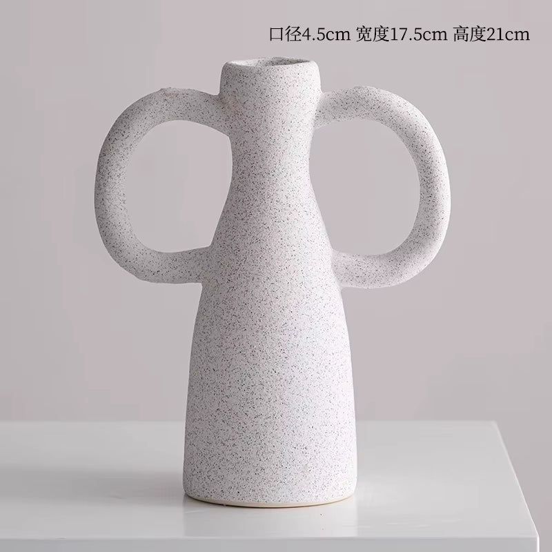 White textured vase with two handles on a light gray background