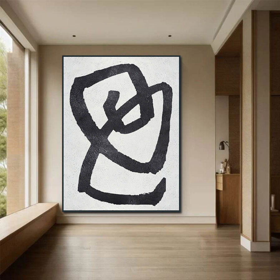 Large abstract black and white artwork on a wall in a modern interior setting.
