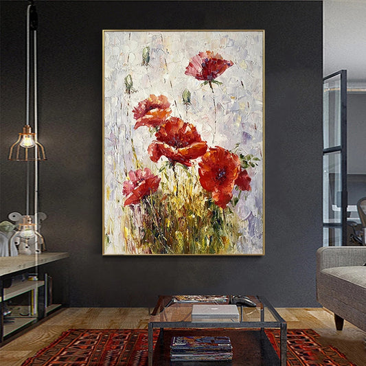 Framed abstract painting of red flowers in a living room setting