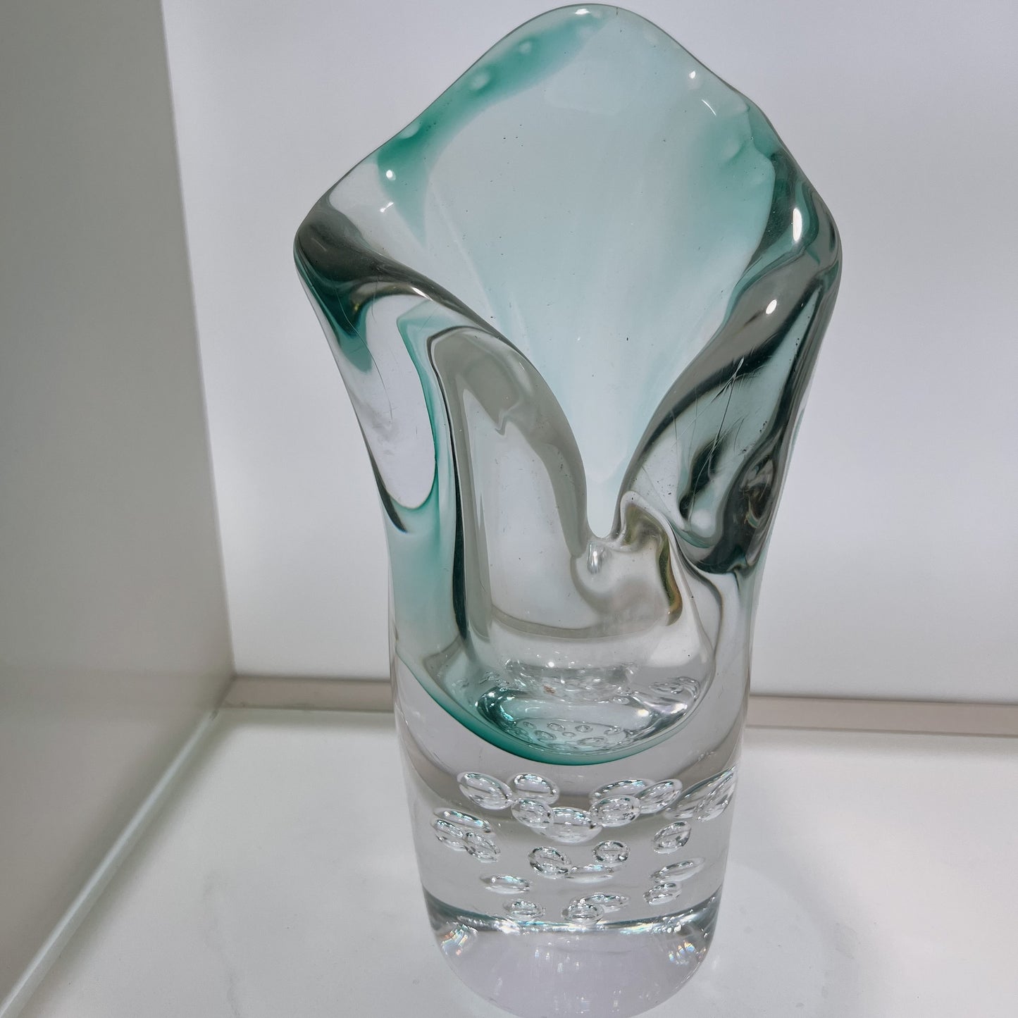 Glass vase with a unique design on a white surface