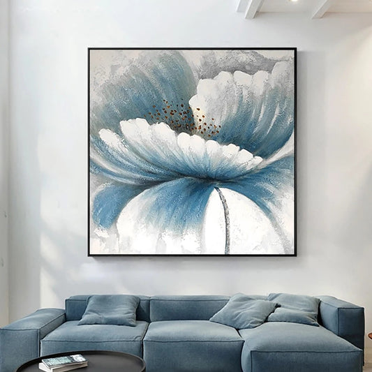 Abstract floral painting in a modern living room with a blue sofa.