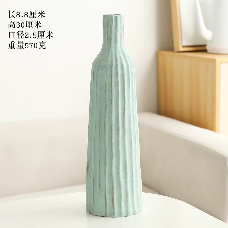 Light blue ceramic vase on a white surface with text in the background