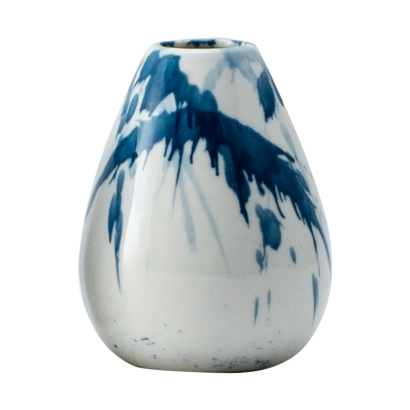 White vase with blue abstract patterns on a white background