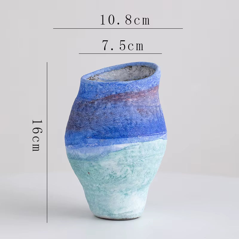 Ceramic vase with blue and green gradient on a light gray background, showing measurements.
