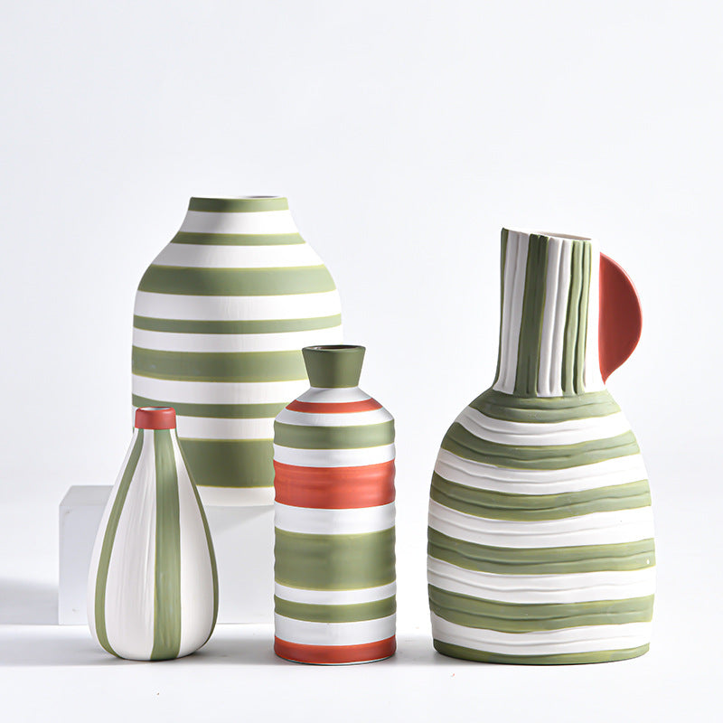 Set of striped ceramic vases on a light background
