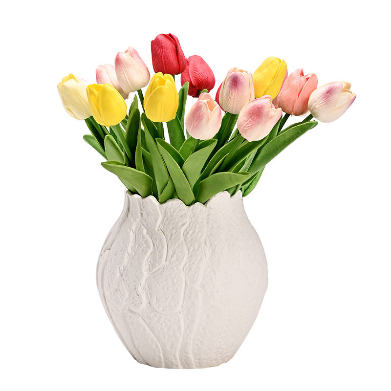 White textured vase with colorful tulips on a white background