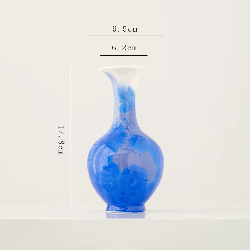 Blue ceramic vase with dimensions on a white background
