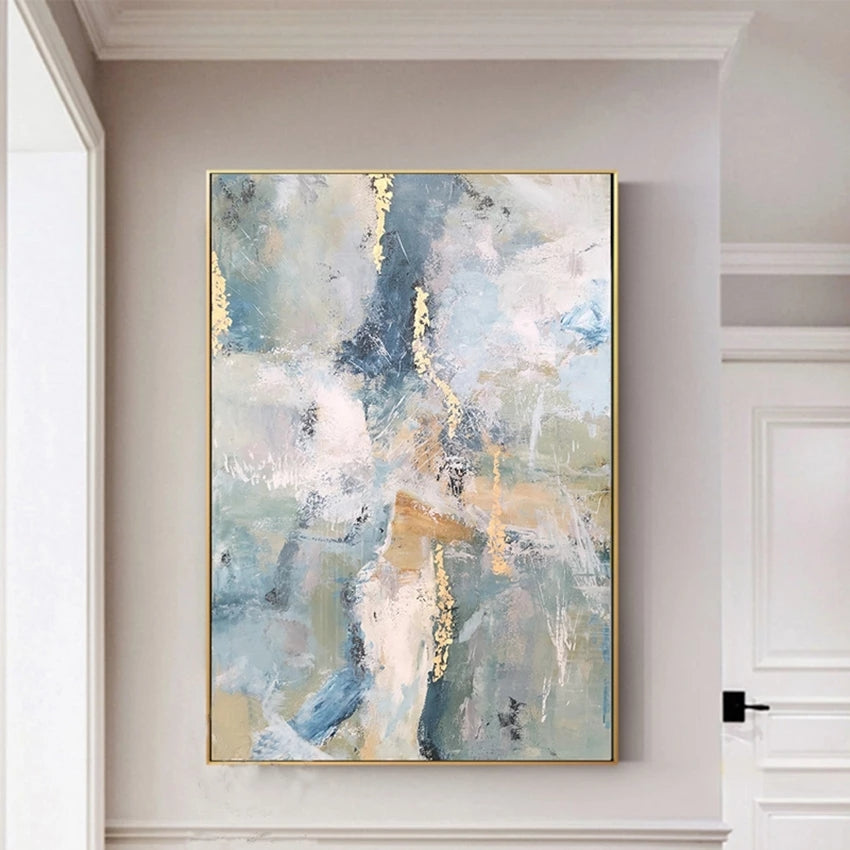 Abstract painting with gold accents on a wall in a room with white walls and a door.