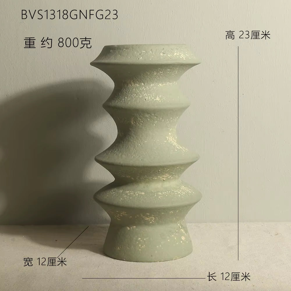 Green ceramic vase with measurements on a neutral background