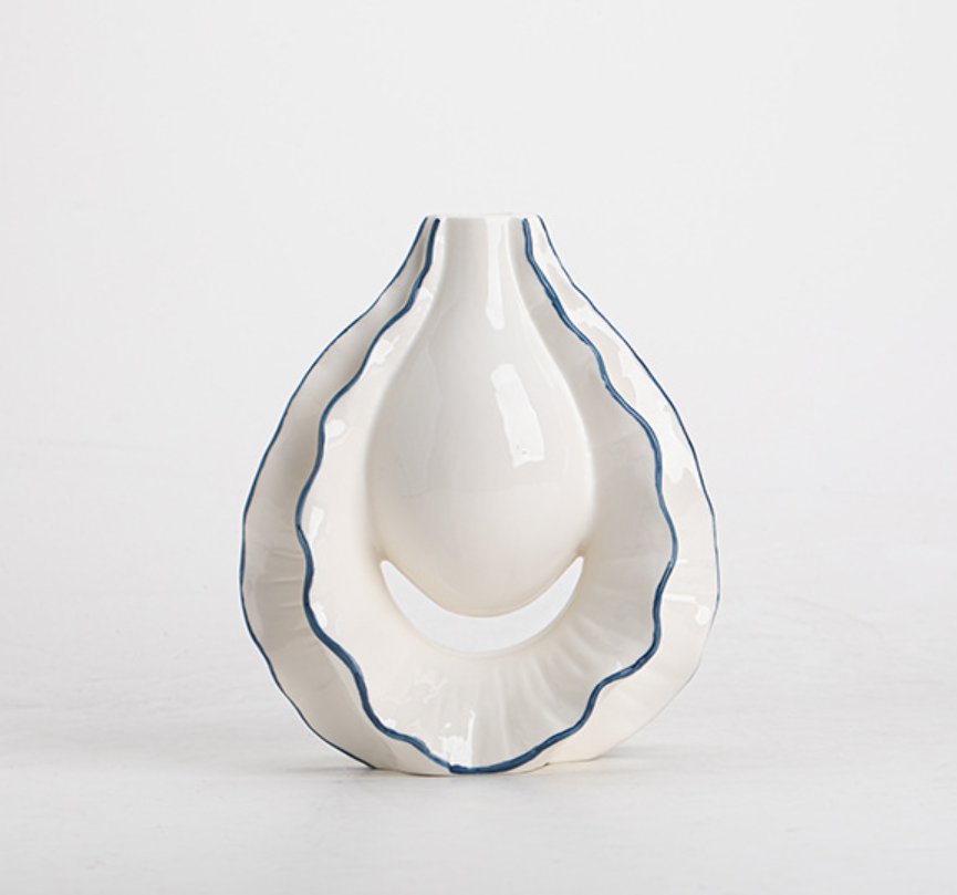 White ceramic vase with blue rim on a light gray background