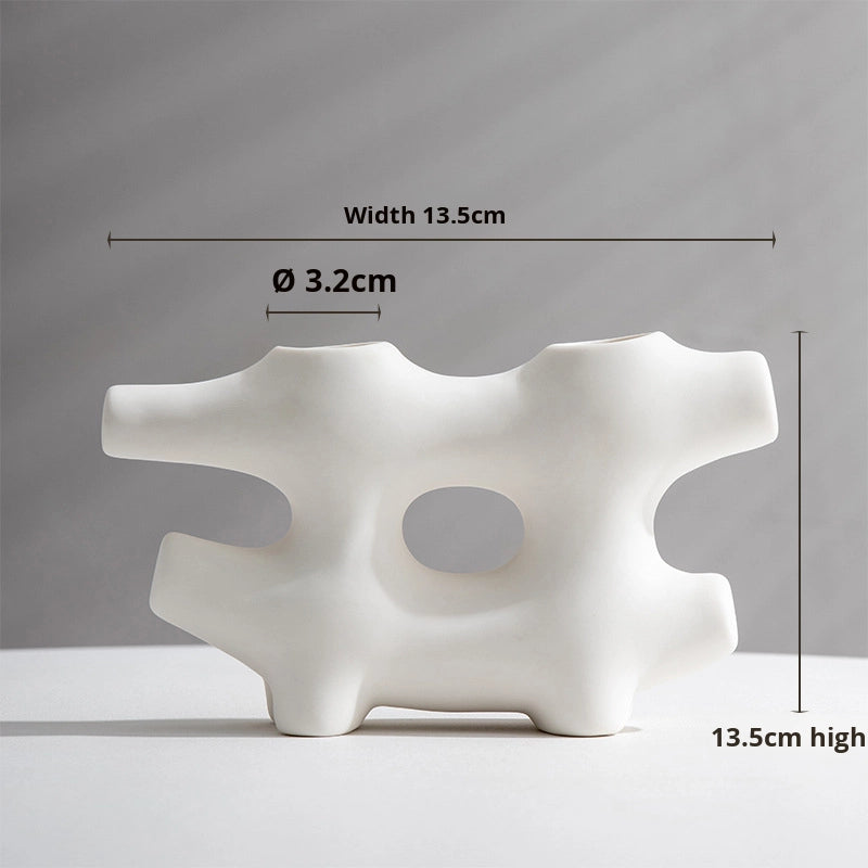 White abstract sculpture with dimensions labeled on a gray background