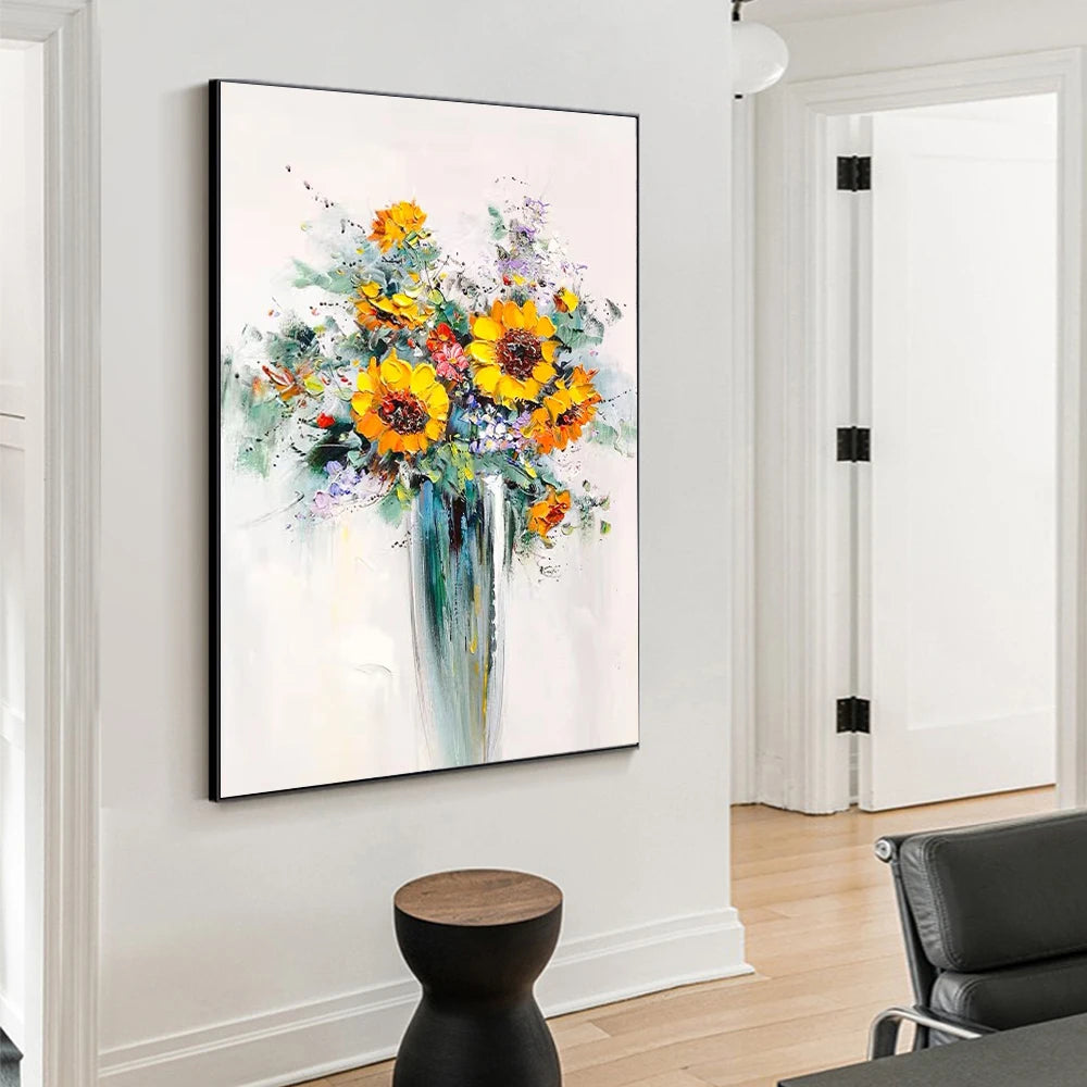 Colorful floral painting on a wall in a room with a chair and small table.