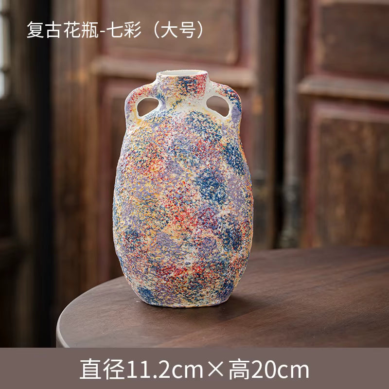 Colorful ceramic vase with textured surface on a wooden surface