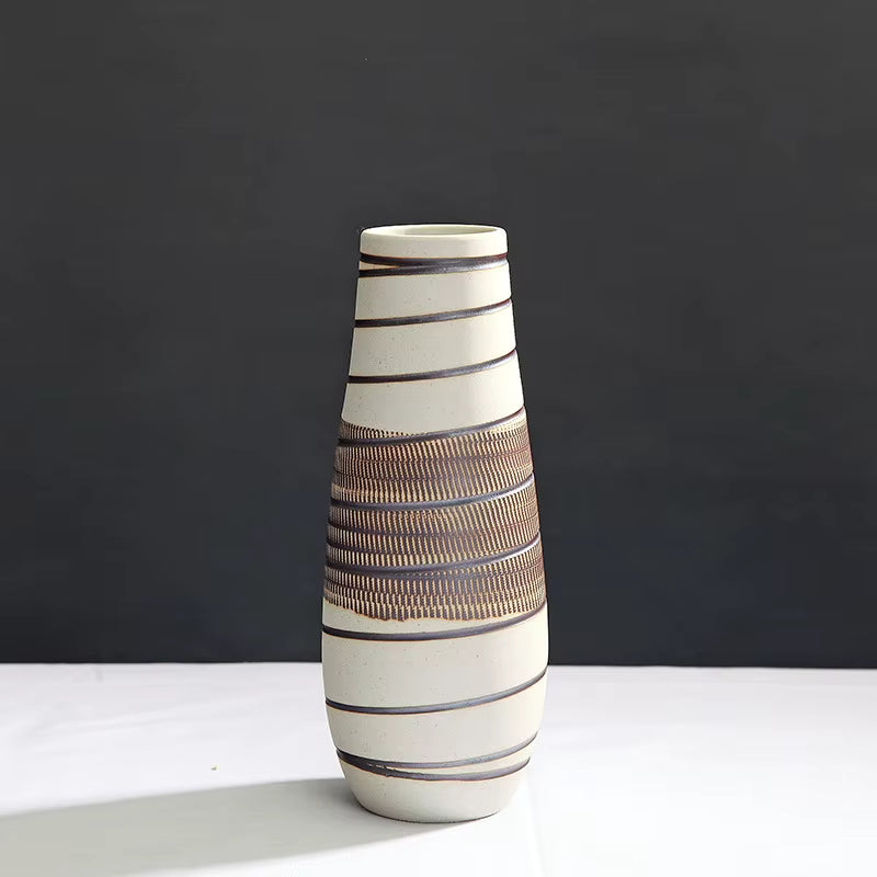 Ceramic vase with striped design on a dark background