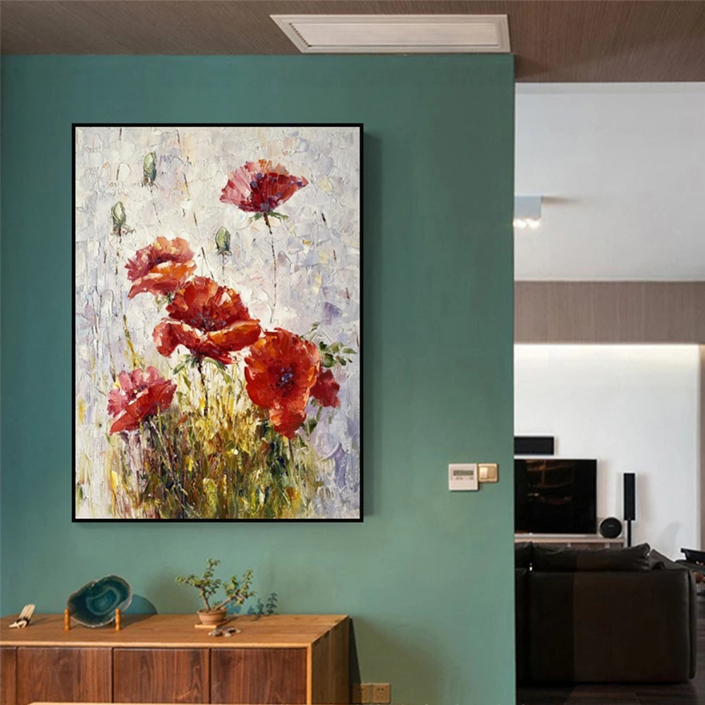 Framed abstract painting of red flowers on a teal wall in a modern room.