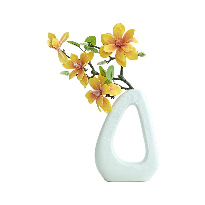 White vase with yellow flowers on a white background