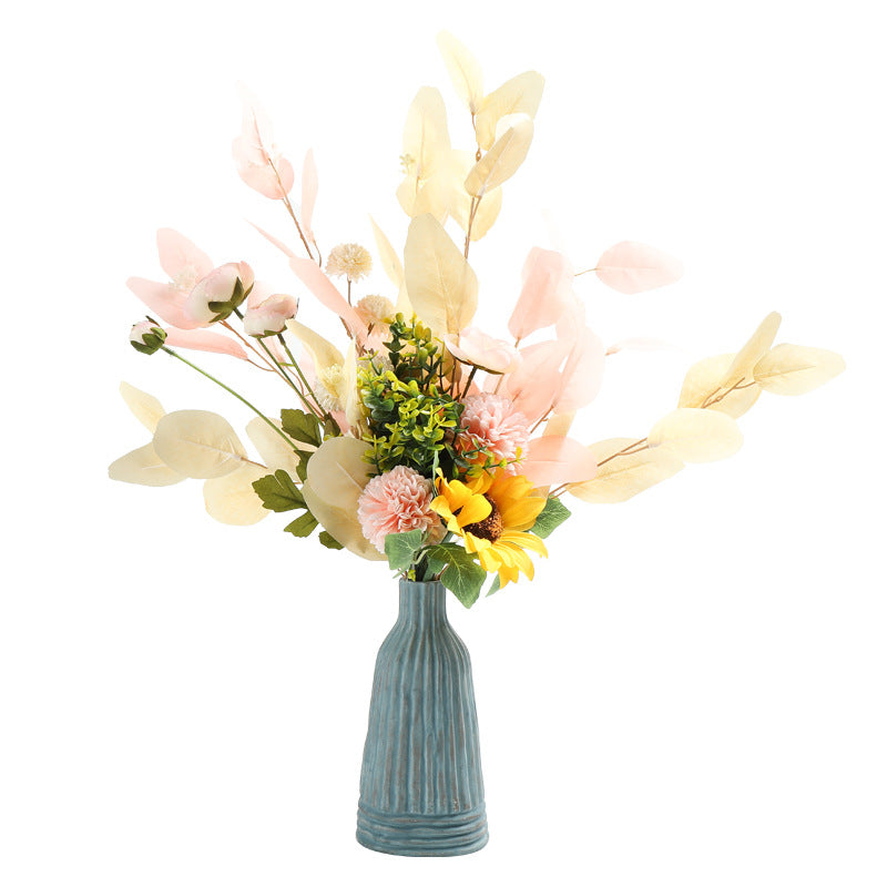 Bouquet of flowers in a textured vase on a white background