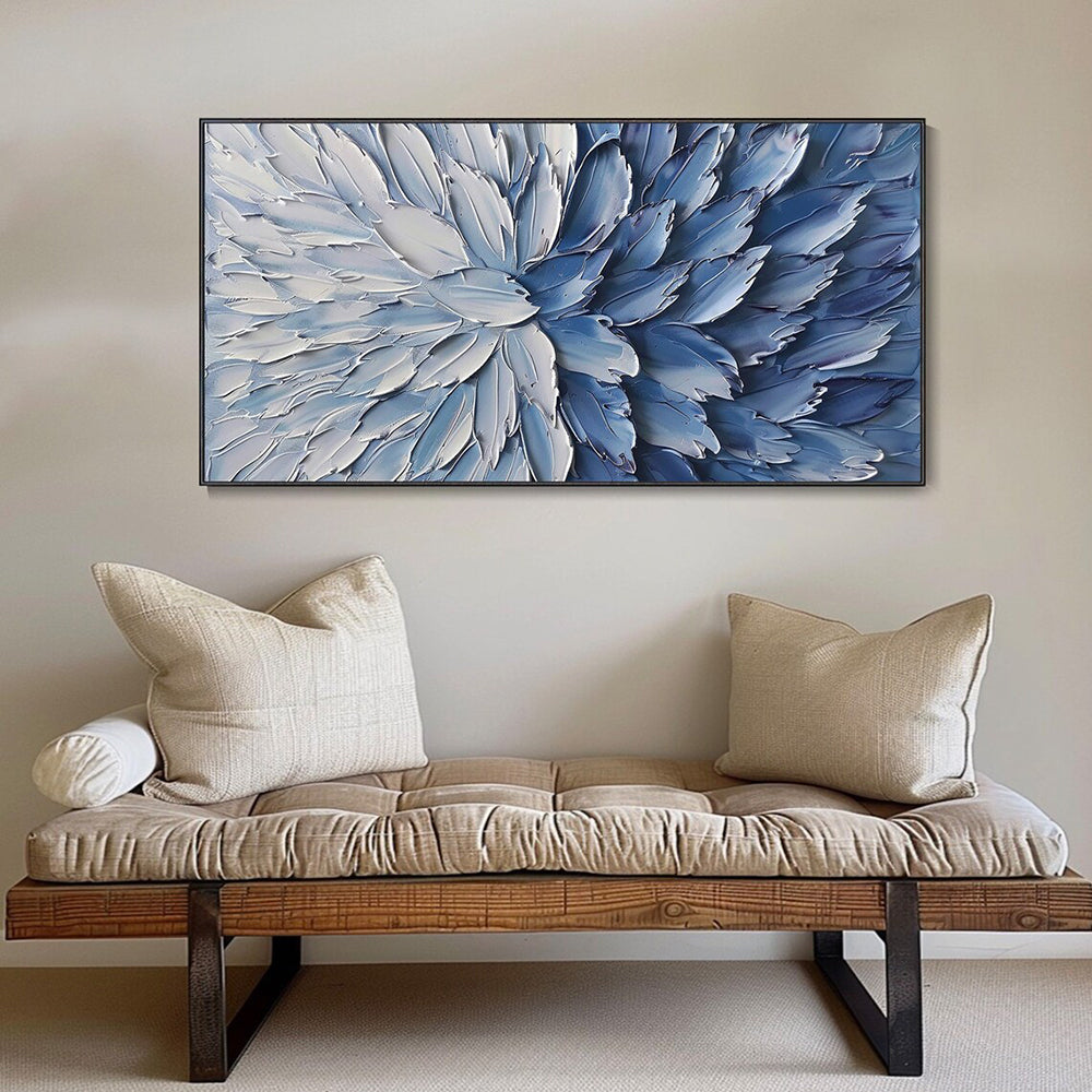 Abstract blue and white floral painting above a wooden bench with beige cushions.