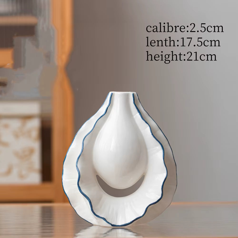 White ceramic vase with blue rim on a reflective surface, with measurements displayed.