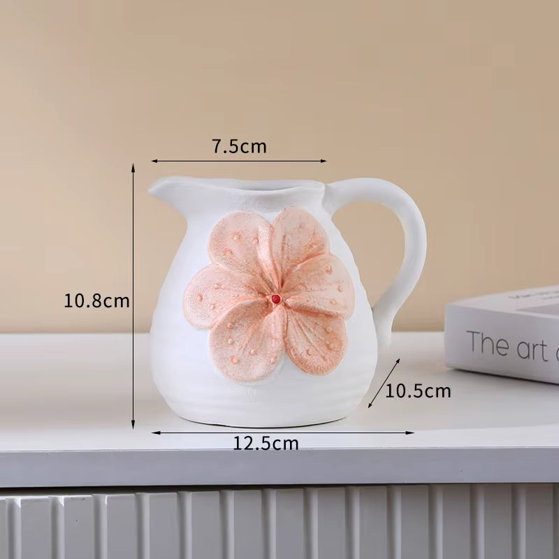 White ceramic pitcher with a pink flower design and measurements on a beige background