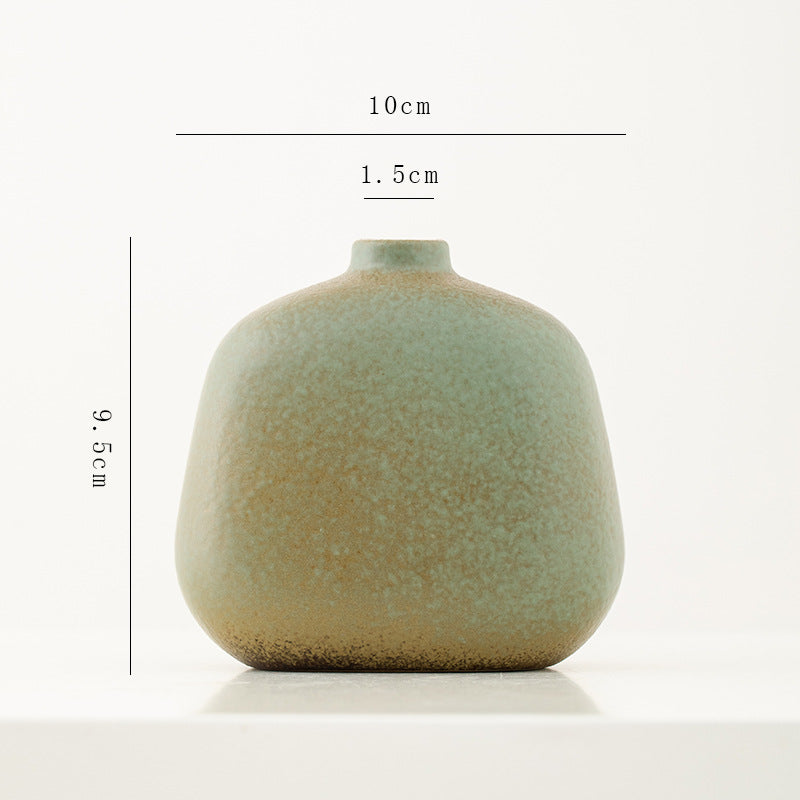 Green ceramic vase with dimensions on a white background